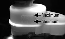 The fluid level must be maintained between the MAX and MIN level marks.