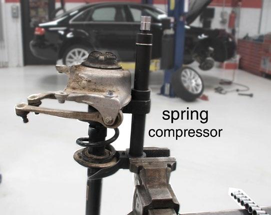 Install Coilover Step 23 Using a suitable spring compressor, compress the coil spring until it no longer exerts pressure against the strut bushing.