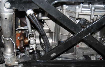 Step 12: Remove the subframe cross brace by removing the six bolts that hold it in place (arrows).