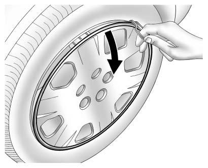 348 Vehicle Care 3. Turn the retainer nut counterclockwise and remove the spare tire. Place the spare tire next to the tire being changed. 4. The jack and tools are stored below the spare tire.