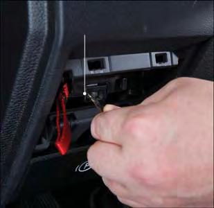 Using a small screwdriver or similar tool, remove the Manual Park Release access cover, which is just above the parking brake release handle, below and to the