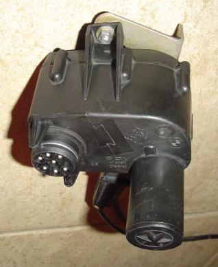 A round male electrical connector for the control cable is also located on the top half.