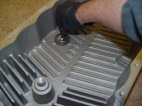 Using a tube and a pump, pump the fluid into the transmission pan through the fill plug hole.