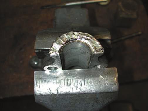 Photo 2: Addding babbitt to the thrust surface of the rear main bearing cap When the thrust has been built up high enough, flip the cap 180 degrees and rebabbitt the other end following the same
