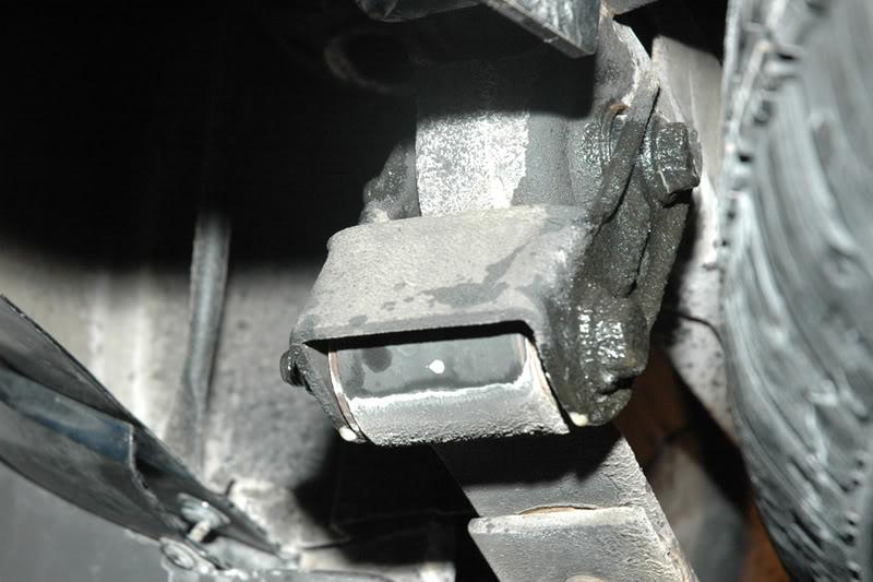 3. Loosen the rear shackle bolts with a 3/4 in wrench and socket. Figure 2: Stock shackles. 4.