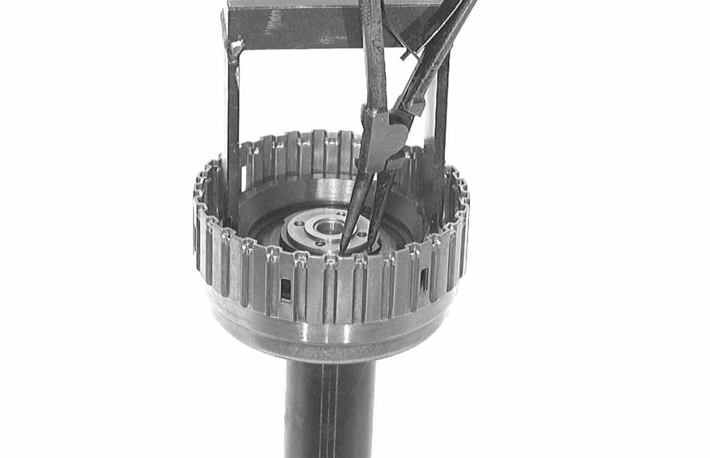 98254 Using assembly fixture 5x46 030 167, press the cup spring out in a mandrel press and