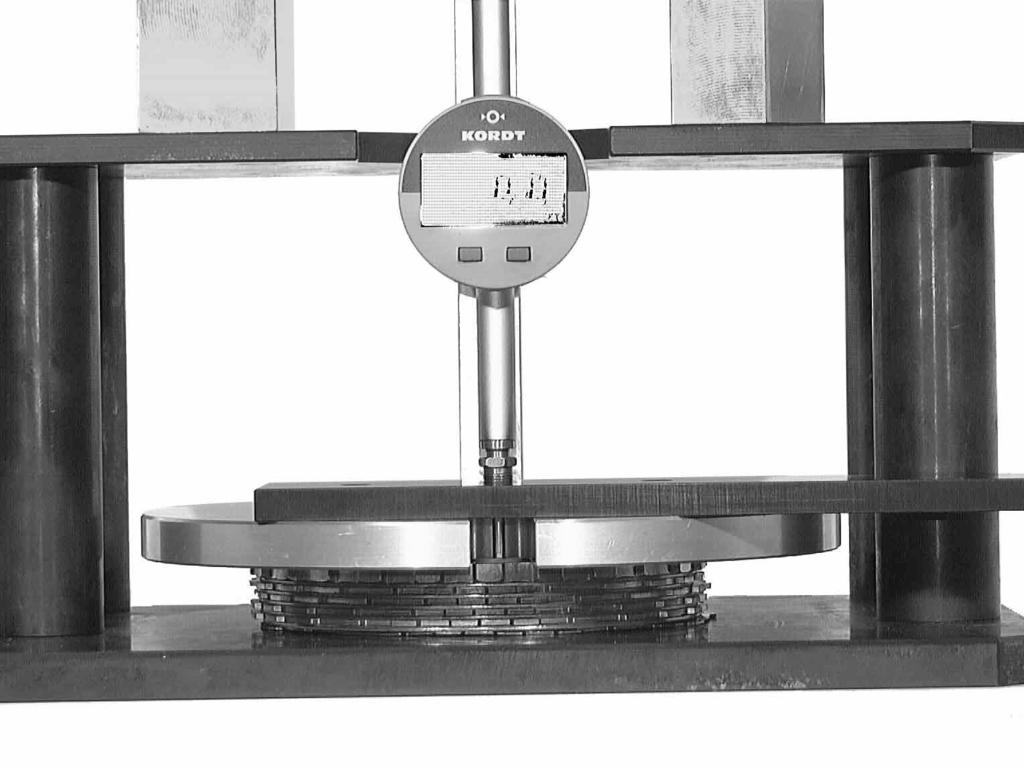 groove on the top disc of the set, and set the dial gauge to 0. Now use the measuring bar to measure down to the base plate.