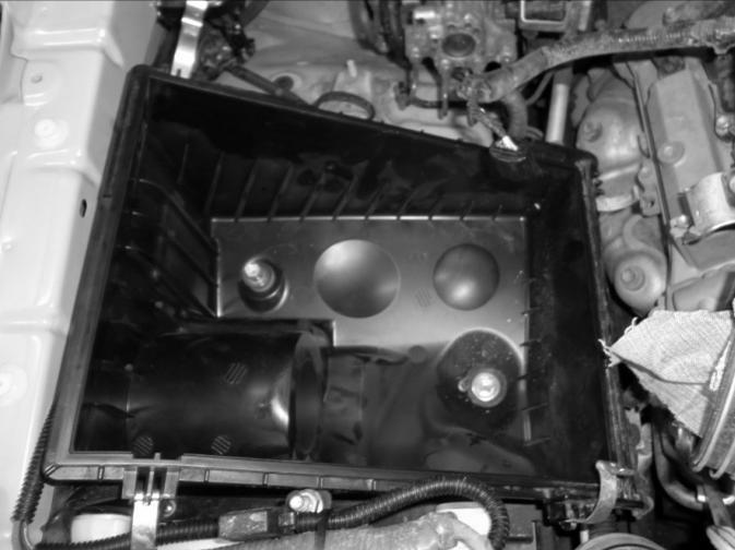 Ensuring that the lower intermediate tube outlet is positioned over the intake socket of the air-cleaner unit base, re-fit the air-cleaner unit base back into its original