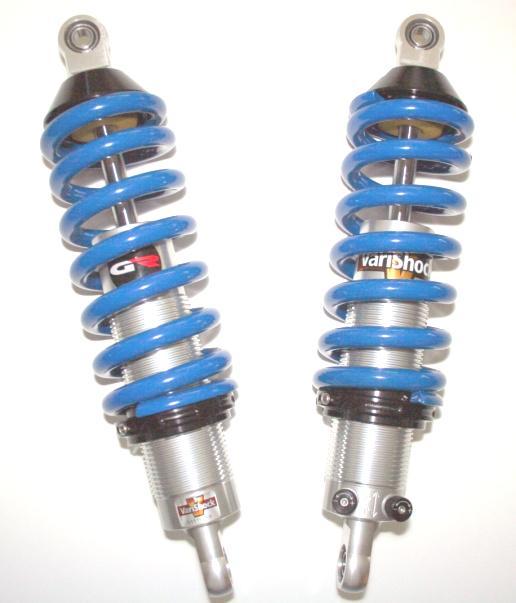 6) Install front springs and upper seats on each shock. 7) Install shocks on car making sure that no part of the shock other than the spherical bearings are contacting any part of the car. IMPORTANT!