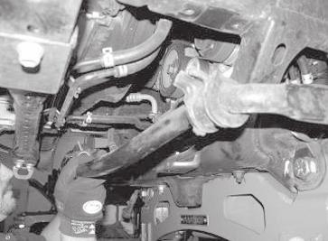 Remove factory mud flaps off front of the vehicle and discard. 4. Remove the nut from the tie rod ends.