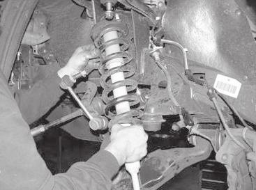Use care not to hit the ball joint. SEE FIGURE 6 FIGURE 8 11. Remove and save the factory lower control arms with the hardware. 12.
