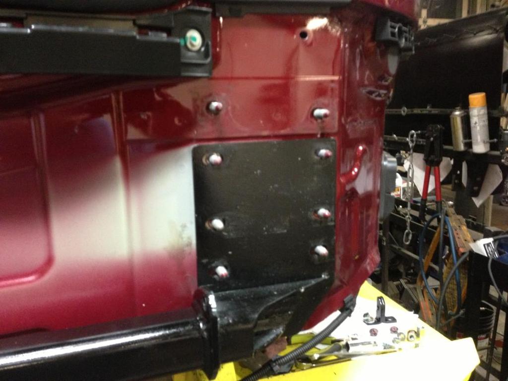 Step 16. Place the trailer hitch into position on the lower six studs.
