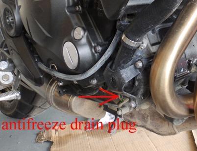 Figure 2. Overflow bottle tilted so that it won't drain when coolant system is emptied.
