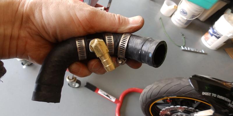 It is now easy to remove the right-side radiator hose from the coolant pump, which you will find is just over 6.5 inches long. Cut away the bottom 1.5 inches of the hose and place that 1.