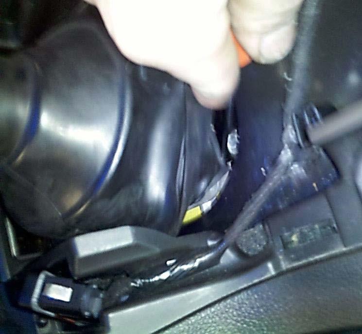 C. Pull the bottom of the boot down and set one side over the lip as shown below. This is where the mini hook tool comes in handy.