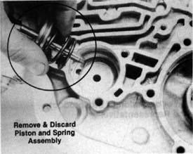 STEP 13 Remove and discard Intermediate band and piston assembly. (See Photo C.) STEP 14 Remove rear servo piston. Remove and discard the two rings from the reverse accumulator. (See Photo D.