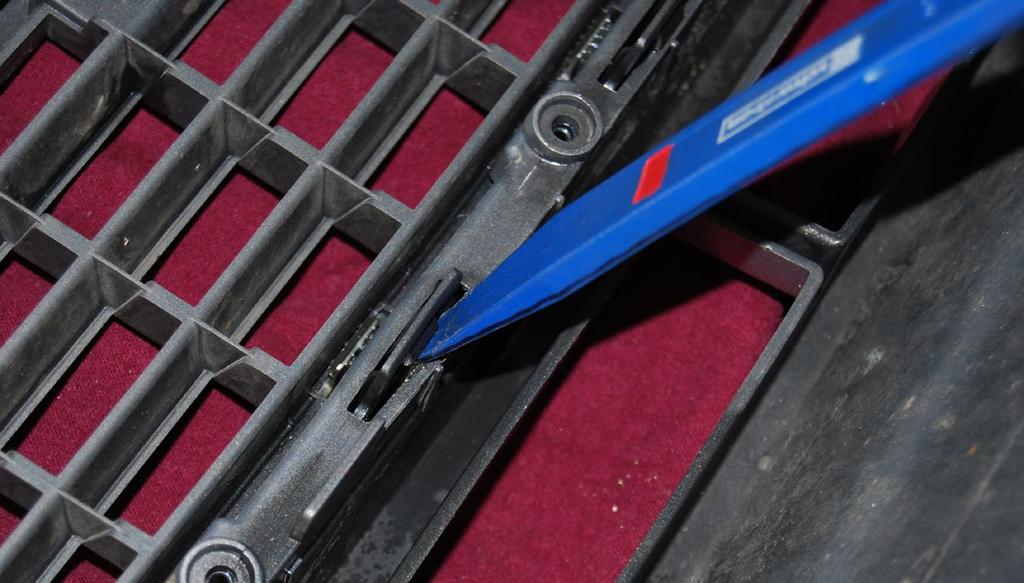 Use a non-marring tool or a screwdriver to push inwards on each clip, this