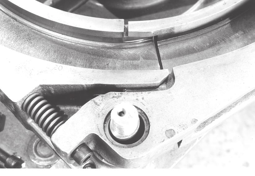 In Figure 1 the release spring bolt has been improperly tightened resulting in abnormal cam wear.