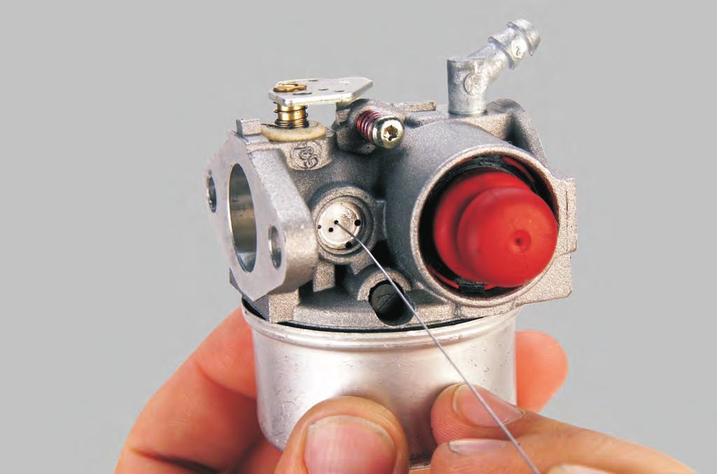 PRY OUT PLUG DO NOT ALLOW CHISEL POINTTO STRIKE CARBURETOR BODY OR CHANNEL REDUCER SMALL CHISEL