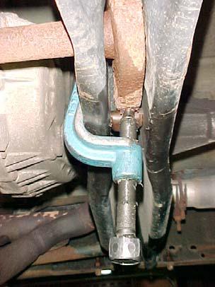 C. USING A PROPERLY RATED TORSION BAR LOADER / UN-LOADER TOOL (KENT MOORE PART NO. 36202 OR ITS EQUIVALENT)INCREASE THE TENSION ON THE STOCK TORSION BAR ADJUSTING ARM.