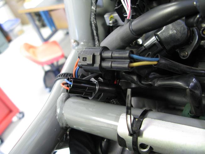 5. Locate the factory Throttle Position Sensor (TPS) connectors, just behind the injectors.