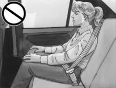 {CAUTION: Never do this. Here a child is sitting in a seat that has a lap-shoulder belt, but the shoulder part is behind the child.