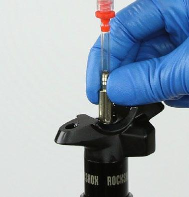 Insert the Reverb Oil Height tool into the post head and draw the excess fluid from the upper post with the