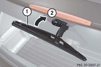 Replacing wiper blades >Removing: Press on retaining springs 1 on both sides of the wiper blade. > Fold the wiper blade away from the wiper arm in the direction of arrow 2 and detach it.