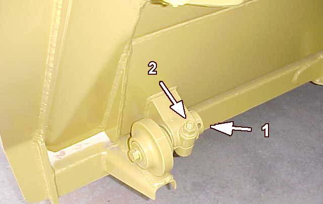 Illustration 20 Inspect the clearance between shim (1) and draft arm wear plate (2). The clearance should be 3 ± 2 mm (0.118 ± 0.080 in). Add shims if necessary.