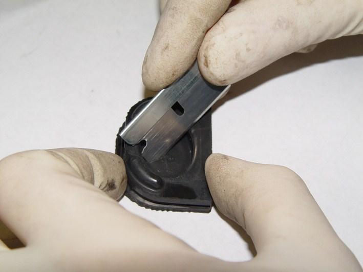 Step 9: With a razor or x-acto knife, cut an X in the middle of the rubber blanking plug.