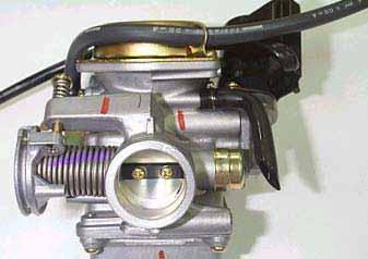4. FUEL SYSTEM E-TON CARBURETOR REMOVAL Open the seat. Remove the luggage box. Loosen the adjustment nut and fixing nut of throttle valve cable, and release the cable from carburetor.