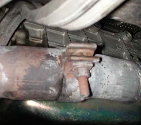 Remove rear-muffler supports from both hangers using a 13-mm open-end wrench (see Fig. 2).