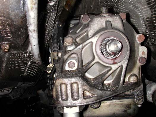 11 Location of shifter cable and electrical connections b. Remove the nine 13-mm bolts holding the extension case to the transmission housing (see Fig. 12). One of nine 13-mm bolts Fig.
