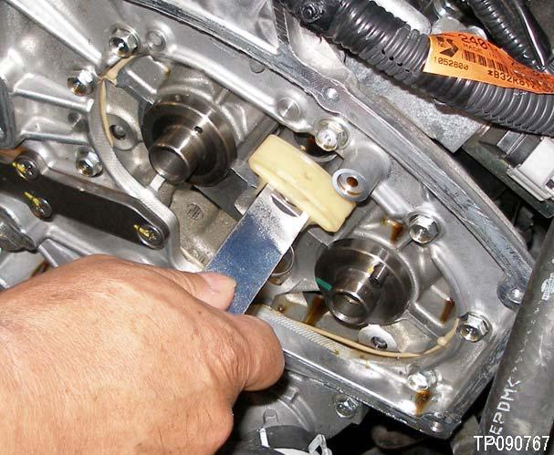 Figure 1 shows J-48761 installed on an AWD vehicle. NOTE: The camshaft sprockets bolts will be removed and installed while being held by all three (3) timing chains.