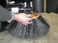 Always check and adjust the sweep pattern after changing the side broom. ADJUSTING THE SIDE BROOM HEIGHT Turn the side broom adjustment knob to change the side broom sweep height.