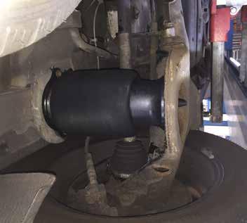 4. RAISE THE REAR AXLE OR REINSTALL THE TIRE AND LOWER THE VEHICLE.