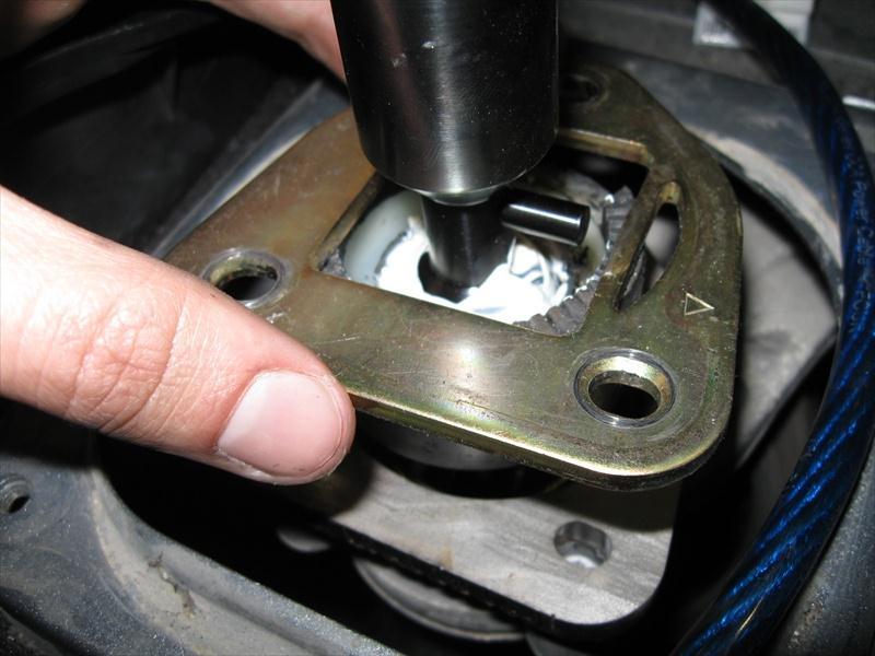 30. Place the reverse lockout plate over the shifter and align the holes with the holes of the spacer and the