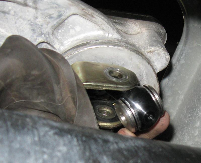 Back under the car, install both stainless steel bushings inside the bottom portion of the TWM short shifter.