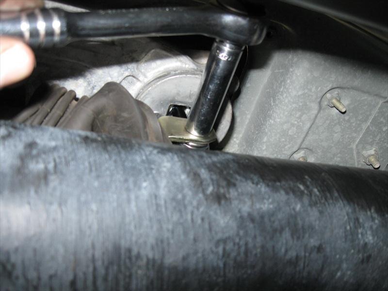 33. Re-install the bolt to hold the shift rod to the shifter. Tighten to approximately 8 lbs-ft. Place the dust boot back over the shifter/shift rod. 34.
