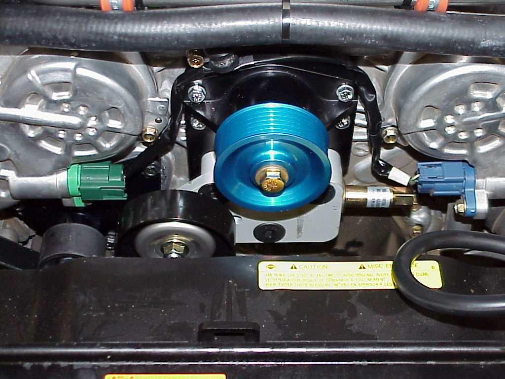 17. Install the lower tensioner assembly onto the just installed drive unit. Use the three supplied M12x50MM flat SHCS and torque to 40 ft-lbs. (PHOTO 13). 18.