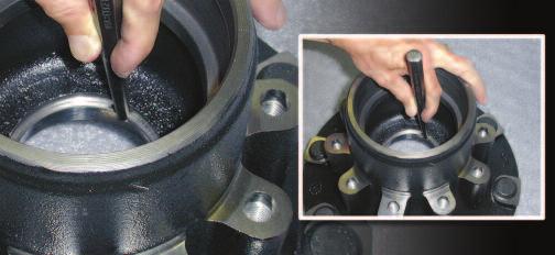 Clean the hub assembly thoroughly. Use a mild steel drift punch or cup driver to drive out the bearing cup.