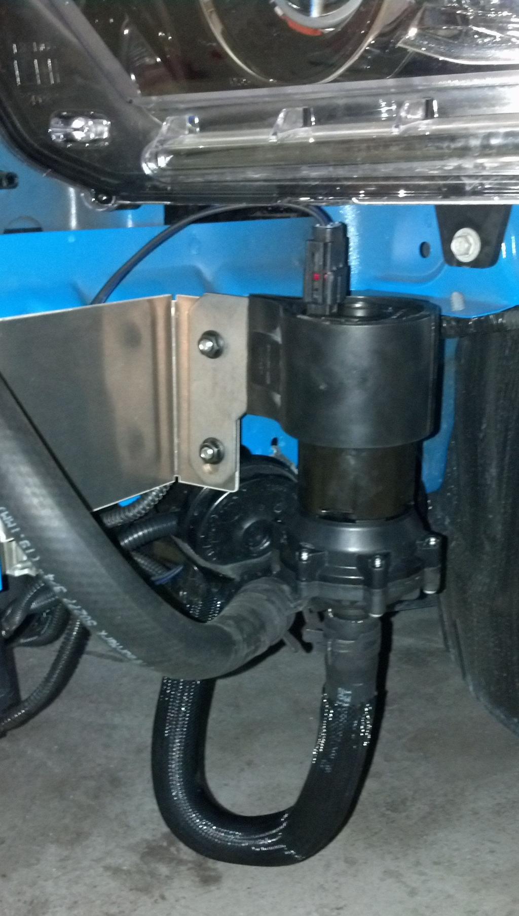 Mount the intercooler pump to the Z bracket with the supplied ¼ carriage bolts and nuts, the inlet should be pointing down (picture on right) and electrical connector pointing up. 4.