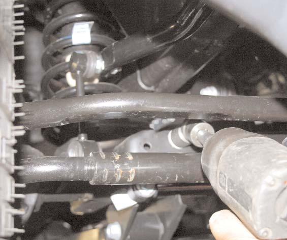 Place bump stop in coil spring, and install coil spring.