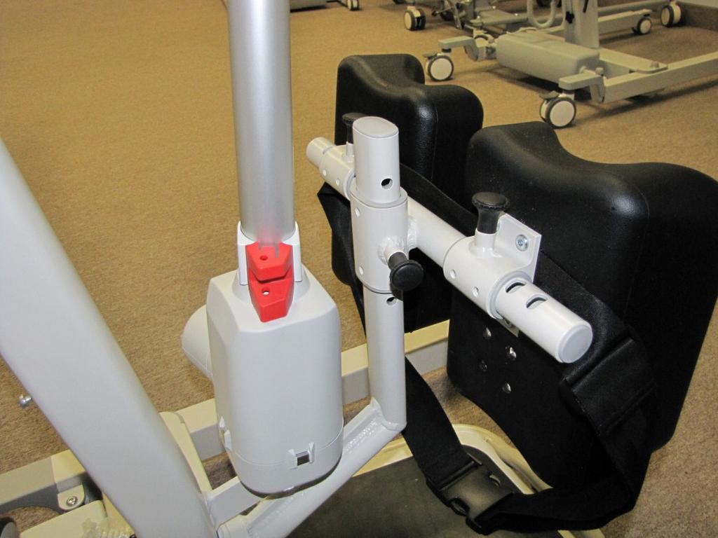 release the plastic knob once it aligns with hole on Knee Pad Height Adjustment Rod as shown in