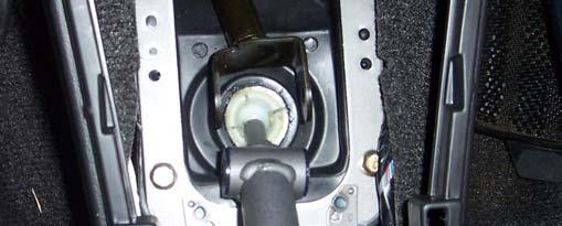 6. Remove the stock shifter by prying back and downward.
