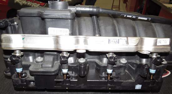 Using a 14mm deep socket, remove the fuel rails from the factory intake manifold.