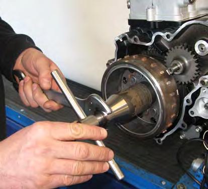 ENGINE DISASSEMBLY - Remove the rotor (3)
