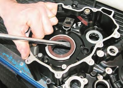 - Loosen the screws (2) using an 8 mm wrench and remove the plate (3) retaining the