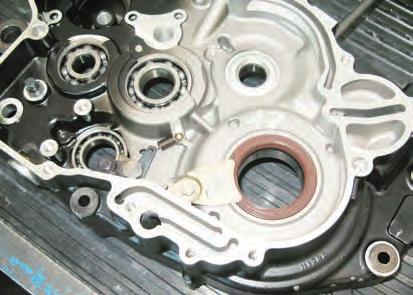 ENGINE DISASSEMBLY Right crankcase crankshaft seal removal - Loosen the screw (1) with an 8 mm wrench and remove the plate (2). - Remove the seal (3) with a screwdriver.