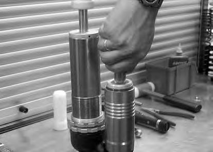 Then slide out the other end, slip the tip of a screwdriver between ring and reservoir and prise off with the other screwdriver.